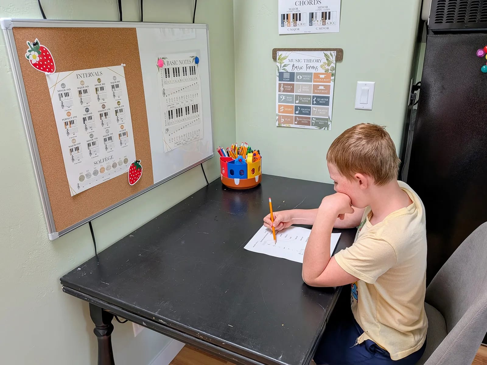 child doing piano theory work